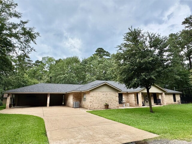 125 Clear Spgs, Trinity, TX 75862 - ranch-style house with driveway, a front yard, central air condition unit, and a garage