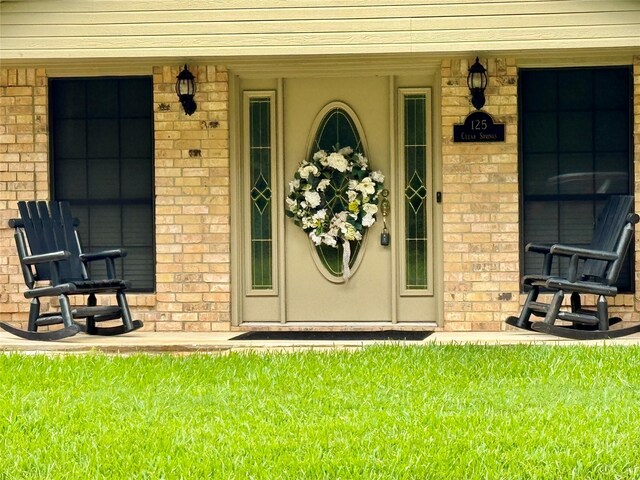 125 Clear Spgs, Trinity, TX 75862 - doorway to property featuring brick siding and covered porch