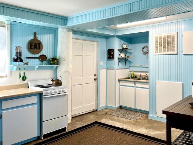 kitchen featuring white electric stove and concrete flooring