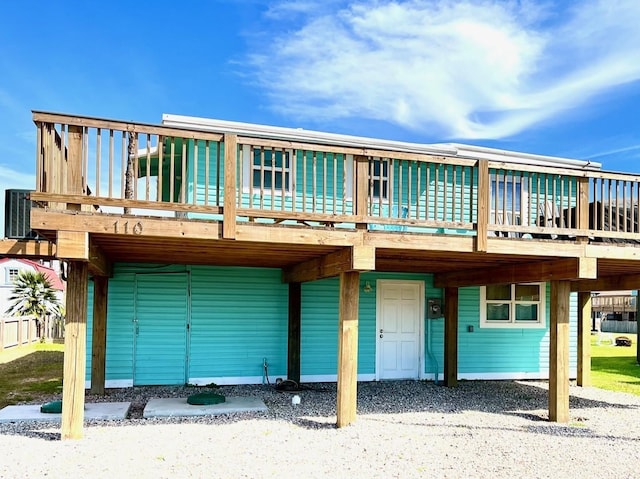 rear view of house with central AC unit and a deck