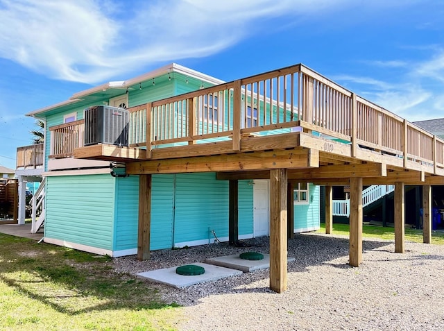 rear view of property with a deck and central air condition unit