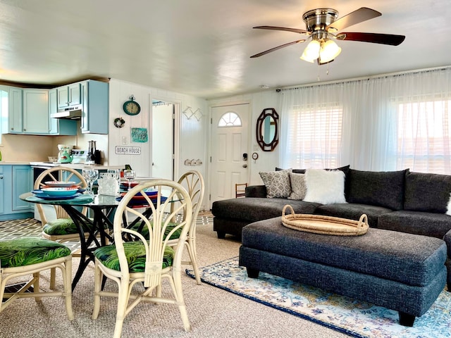 carpeted living room with ceiling fan