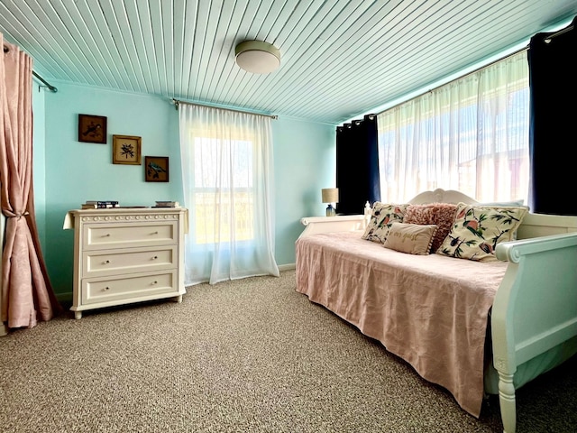 carpeted bedroom with wooden ceiling