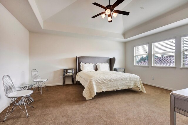 carpeted bedroom featuring vaulted ceiling, a ceiling fan, and baseboards