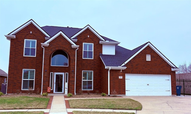 view of property featuring a garage and a front yard