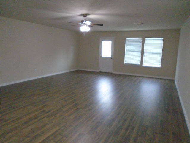 spare room with ceiling fan and dark hardwood / wood-style flooring