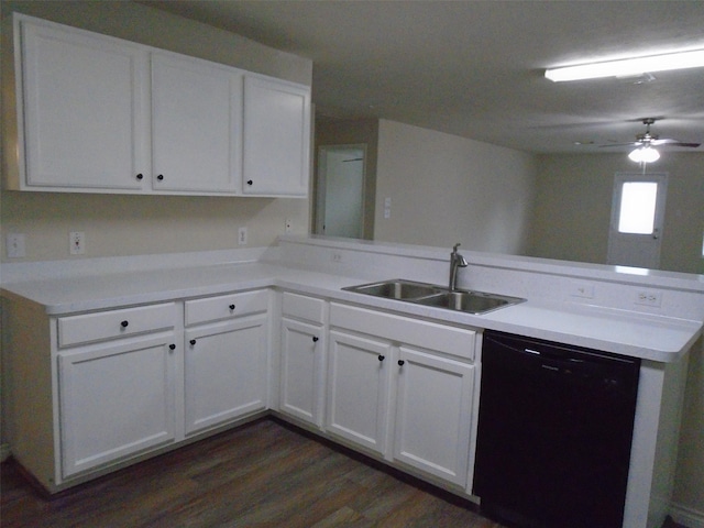 kitchen with dark wood-type flooring, sink, white cabinetry, black dishwasher, and kitchen peninsula