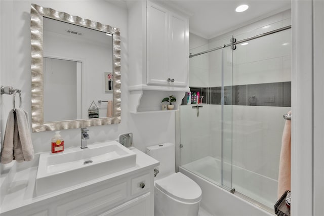 full bathroom with vanity, shower / bath combination with glass door, and toilet