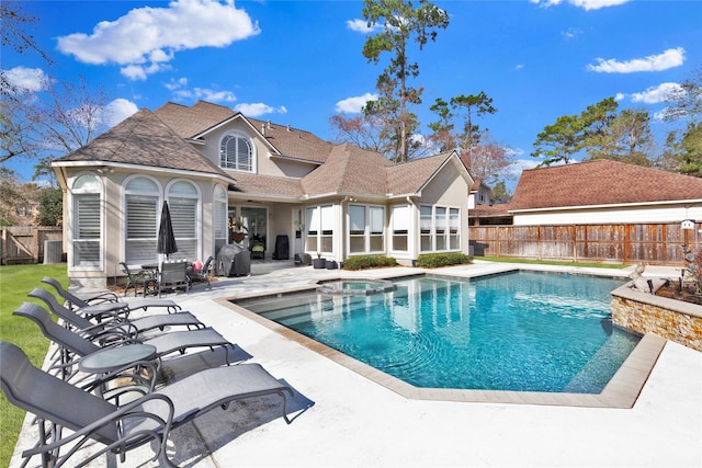 view of swimming pool with an in ground hot tub and a patio