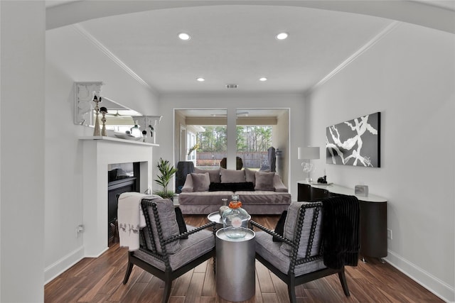 living room featuring ornamental molding and dark hardwood / wood-style floors