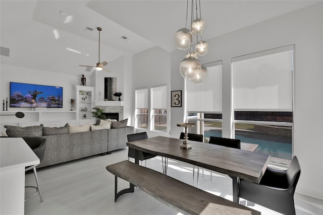 dining space with ceiling fan and light wood-type flooring