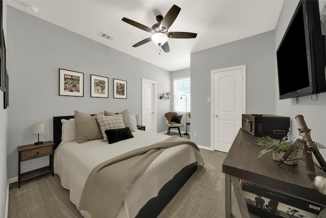 bedroom with baseboards, dark carpet, visible vents, and a ceiling fan