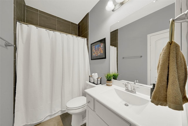 full bathroom with curtained shower, vanity, and toilet