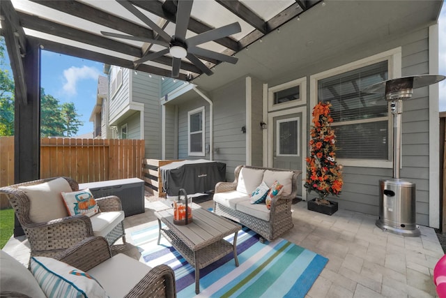 view of patio / terrace with a ceiling fan, fence, an outdoor living space, and area for grilling