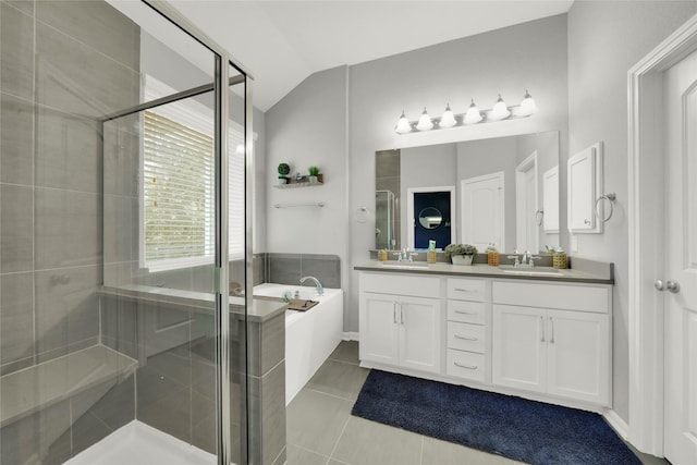 full bathroom with vaulted ceiling, a shower stall, and a sink