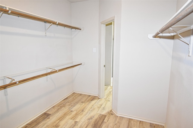 walk in closet with light wood-type flooring