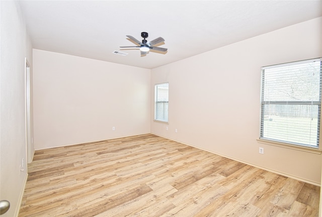 empty room featuring light hardwood / wood-style flooring and ceiling fan