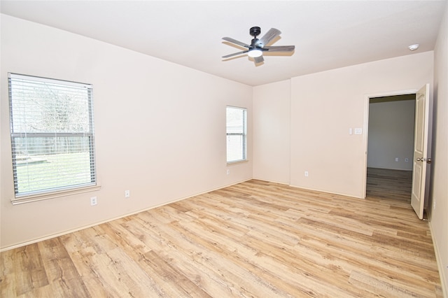 spare room with light hardwood / wood-style flooring and ceiling fan