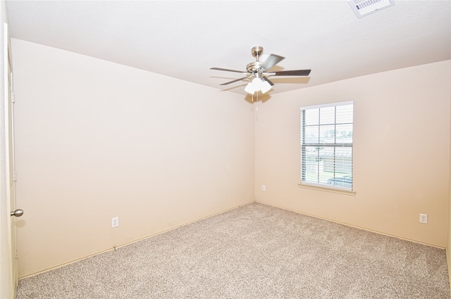 spare room featuring ceiling fan and carpet flooring