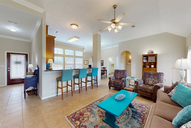 living room with ornamental molding, lofted ceiling, light tile patterned flooring, and ceiling fan