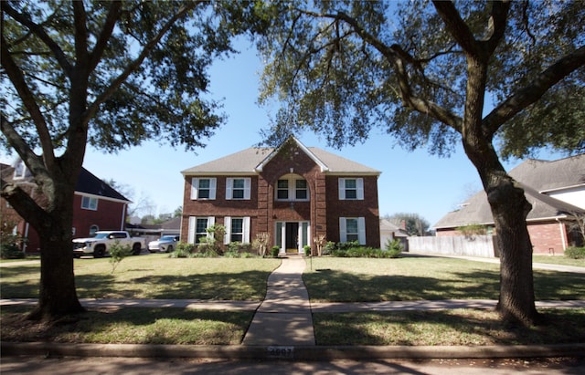 colonial home with a front yard