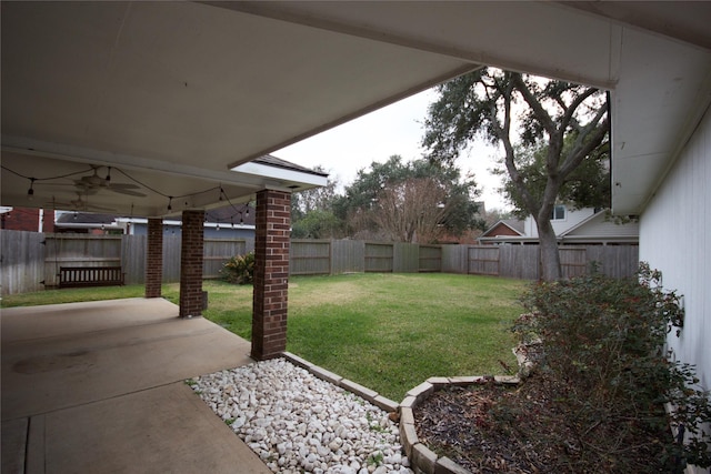 view of yard with a patio and ceiling fan