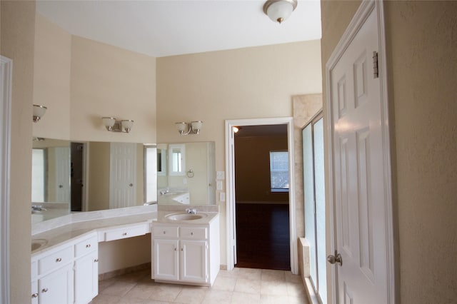 bathroom with vanity, a shower with door, tile patterned flooring, and a high ceiling