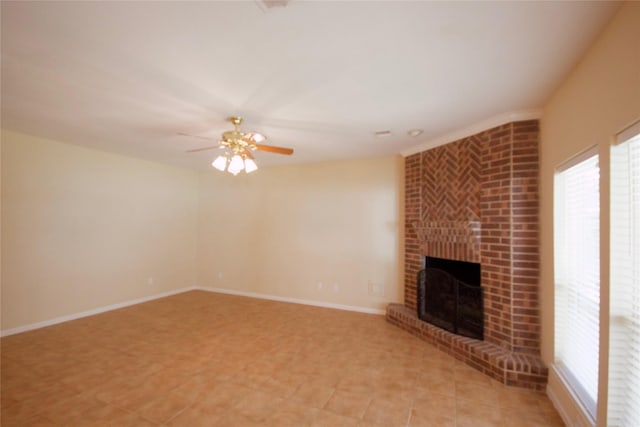 unfurnished living room featuring ceiling fan and a brick fireplace