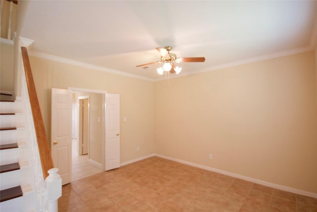 spare room with crown molding and ceiling fan