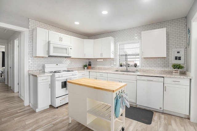 kitchen with white appliances and white cabinets