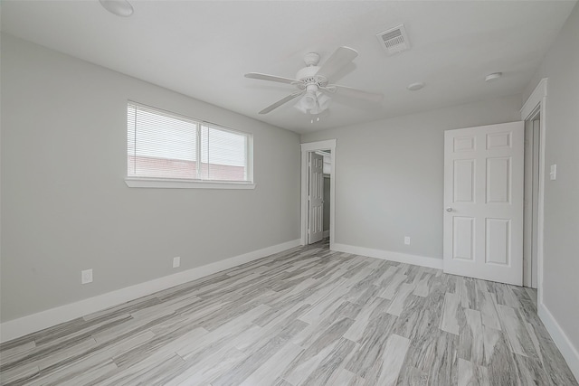 unfurnished bedroom with ceiling fan and light wood-type flooring