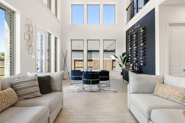 living room featuring a high ceiling and light wood-type flooring