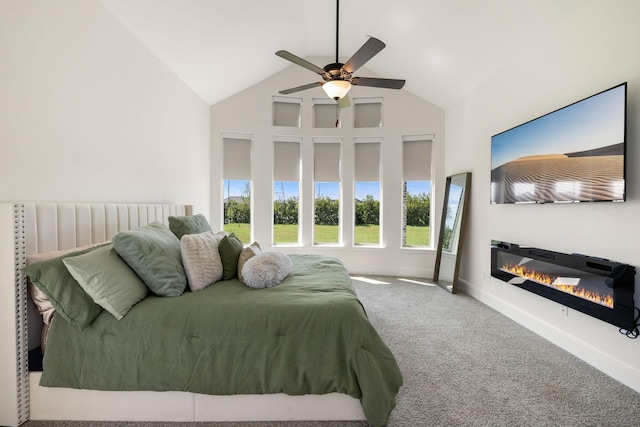 carpeted bedroom with ceiling fan and high vaulted ceiling