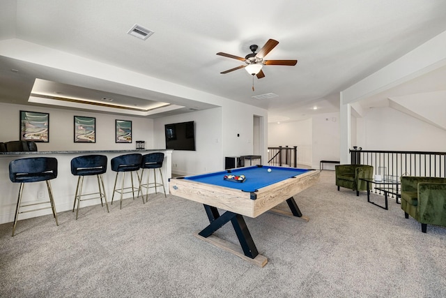 playroom featuring bar, light colored carpet, pool table, and a tray ceiling