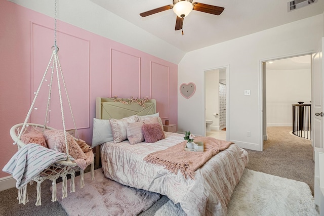 bedroom featuring vaulted ceiling, carpet floors, connected bathroom, and ceiling fan