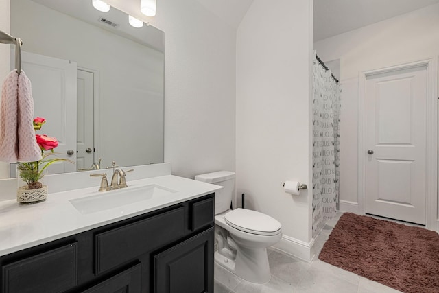 bathroom featuring vanity, tile patterned floors, and toilet