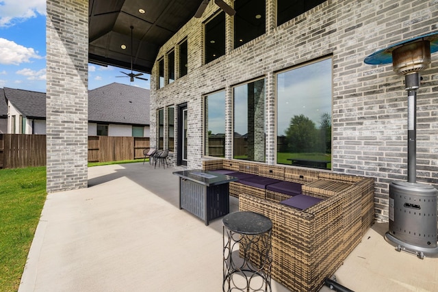 view of patio / terrace with ceiling fan and an outdoor fire pit