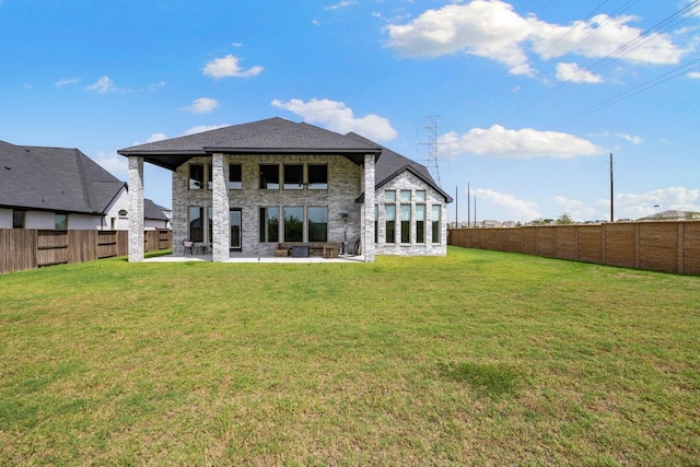 back of house featuring a patio and a lawn