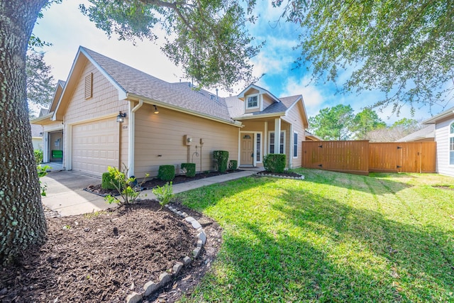 view of front of house with a garage, a gate, fence, and a front yard