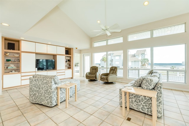 tiled living room with ceiling fan, high vaulted ceiling, and built in features