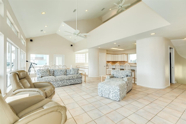 tiled living room featuring high vaulted ceiling and ceiling fan