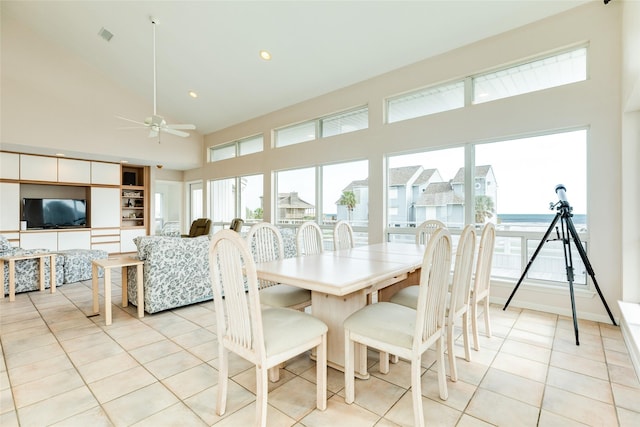 tiled dining area featuring plenty of natural light, high vaulted ceiling, and ceiling fan