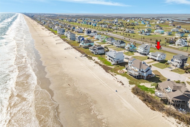 birds eye view of property with a view of the beach and a water view