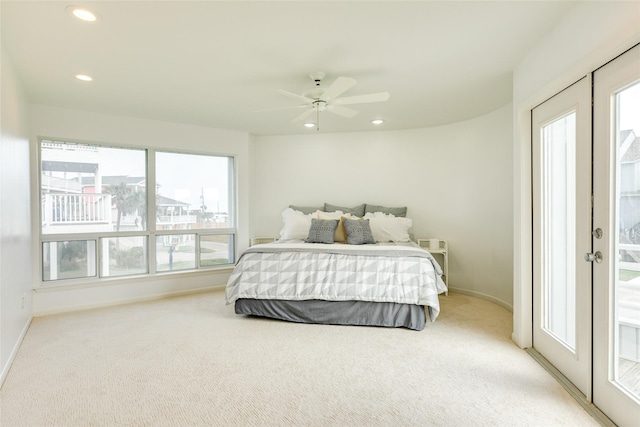 bedroom featuring french doors, ceiling fan, light carpet, and access to outside