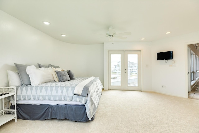 carpeted bedroom with french doors, ceiling fan, and access to outside