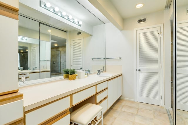 bathroom with tile patterned flooring and vanity