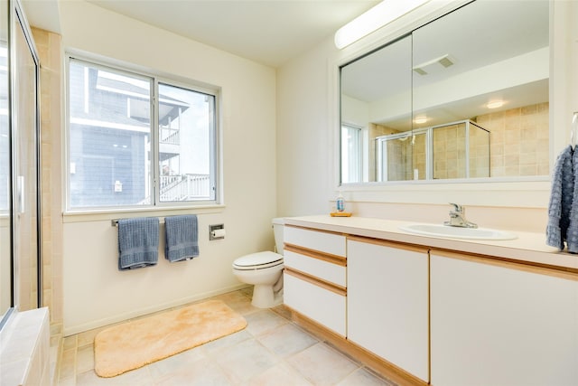 bathroom featuring a shower with door, vanity, tile patterned flooring, and toilet