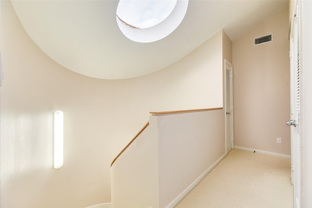 hallway with light colored carpet