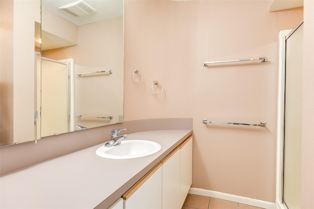 bathroom featuring vanity, tile patterned floors, and walk in shower