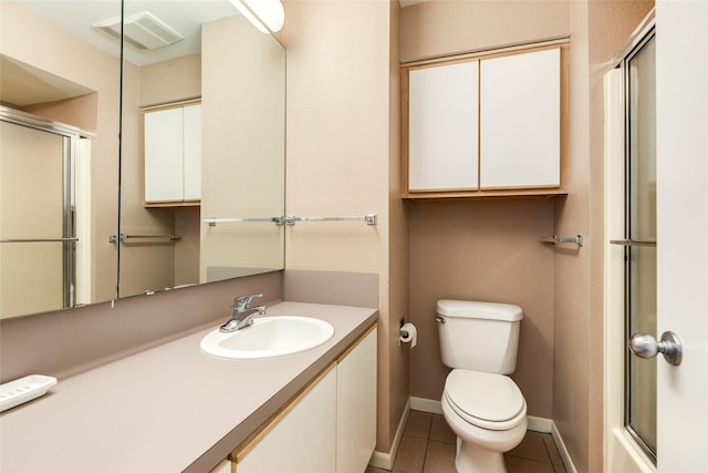 bathroom featuring tile patterned floors, toilet, an enclosed shower, and vanity